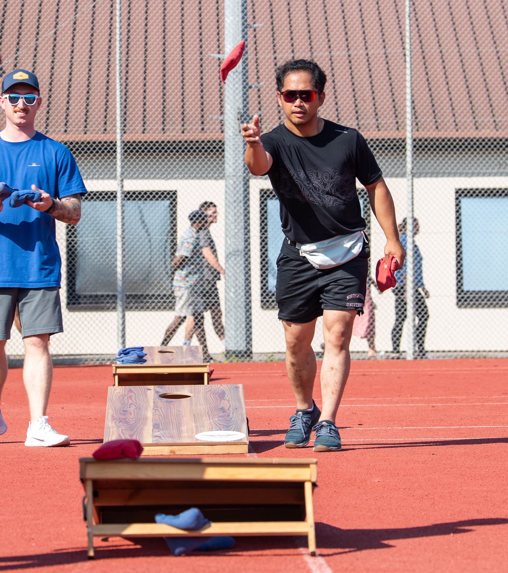 Someone playing cornhole.