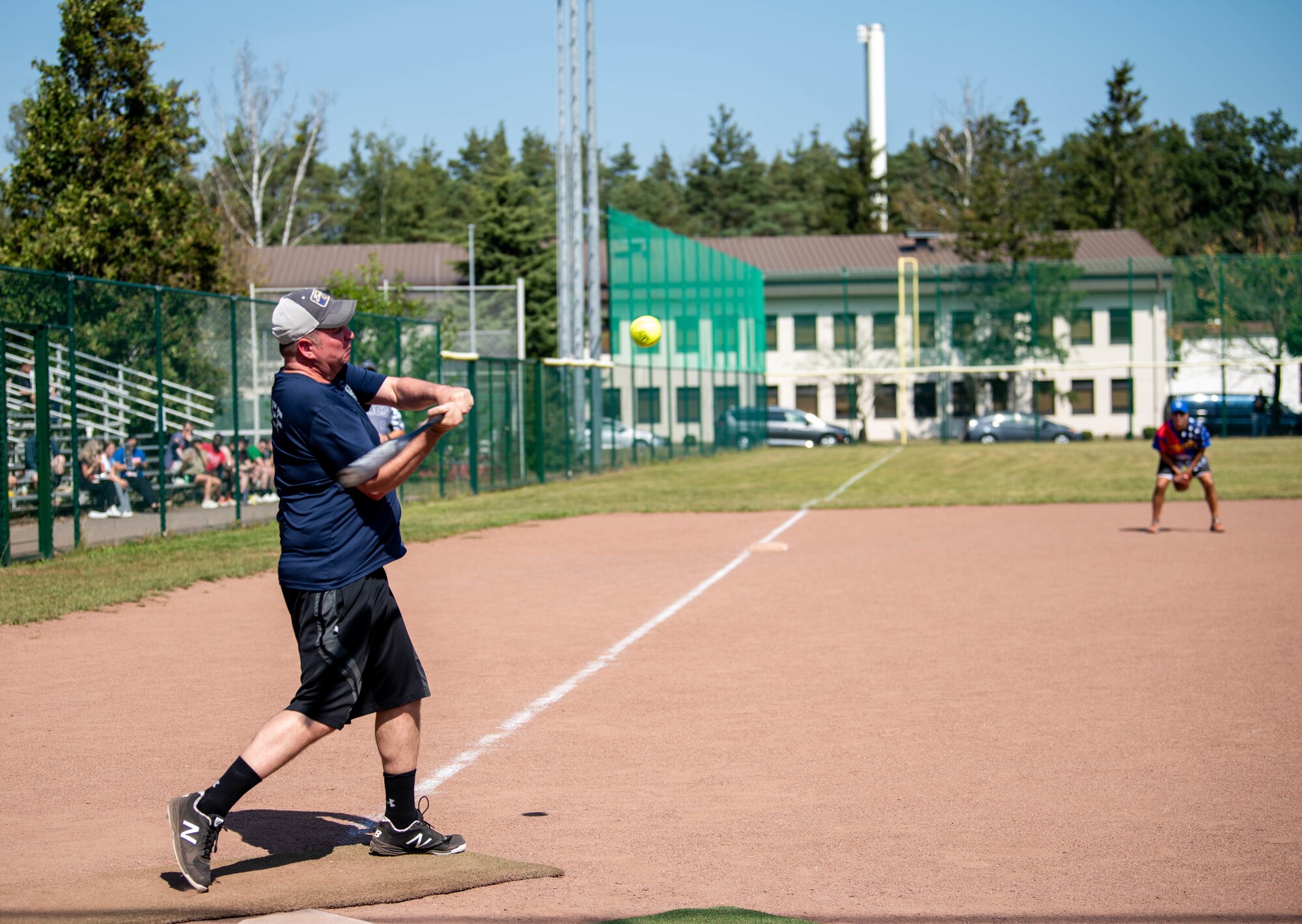 Someone hitting a ball in a softball game.