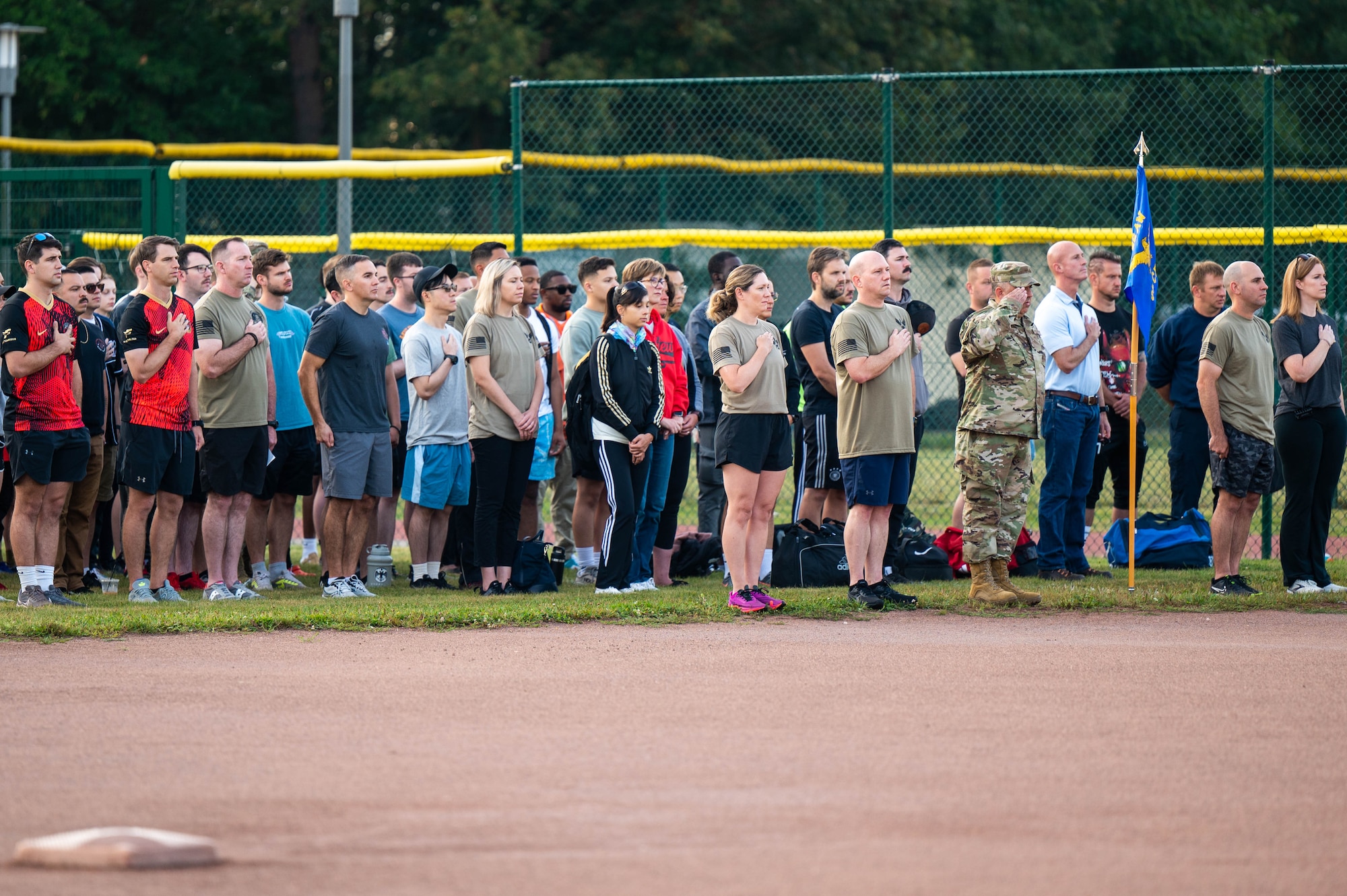 People standing in a crowd during the Pledge of Allegiance.