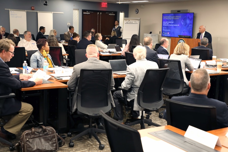 People seated in a training room listening to a speaker.