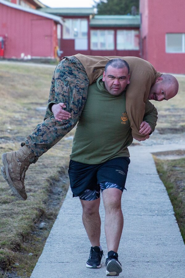Cuerpo de Infantería de Marina Cabo Primero (Chilean Marine Corporal) Juan Tapia Pasten, an artilleryman with Battery 421, carries Lance Cpl. Gregory Moore a team leader with 1st Battalion, 24th Marine Regiment, 4th Marine Division while conducting physical training at Destacamento de Infanteria Marina Number 4 (Chilean Marine Detachment Number 4) “Cochrane”, Chile, during exercise UNITAS LXV, Sep. 3, 2024. The Marines conducted physical training to build camaraderie and esprit de corps, and maintain fitness standards. UNITAS, which is Latin for “unity,” was conceived in 1959 and has taken place annually since first conducted in 1960. This year marks the 65th iteration of the world’s longest running annual multinational maritime exercise. (U.S. Marine Corps photo by Sgt. Gabriel Durand)