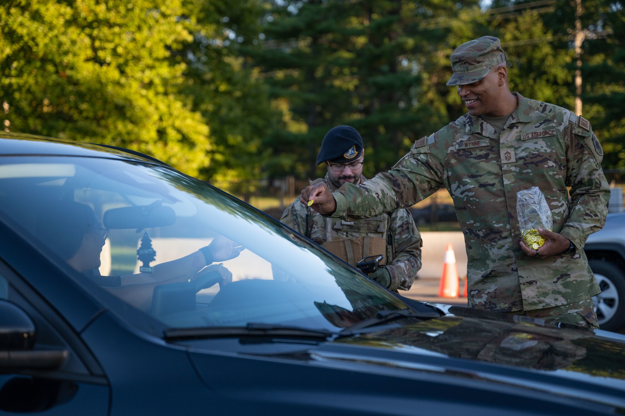 U.S. Air Force Chief Master Sgt. Michael Wynne, 87th Air Base Wing command chief, passes out pins during a National Suicide Prevention Awareness Month event at Joint Base McGuire-Dix-Lakehurst, N.J., Sept. 3, 2024. The month of September is the National Suicide Prevention Awareness Month where many organizations make a concerted effort to destigmatize the mental health struggles that many may face and take the opportunity to educate the public on recognizing signs someone is need of support as well as the avenues to receive support. (U.S. Air Force photo by Staff Sgt. Monica Roybal)