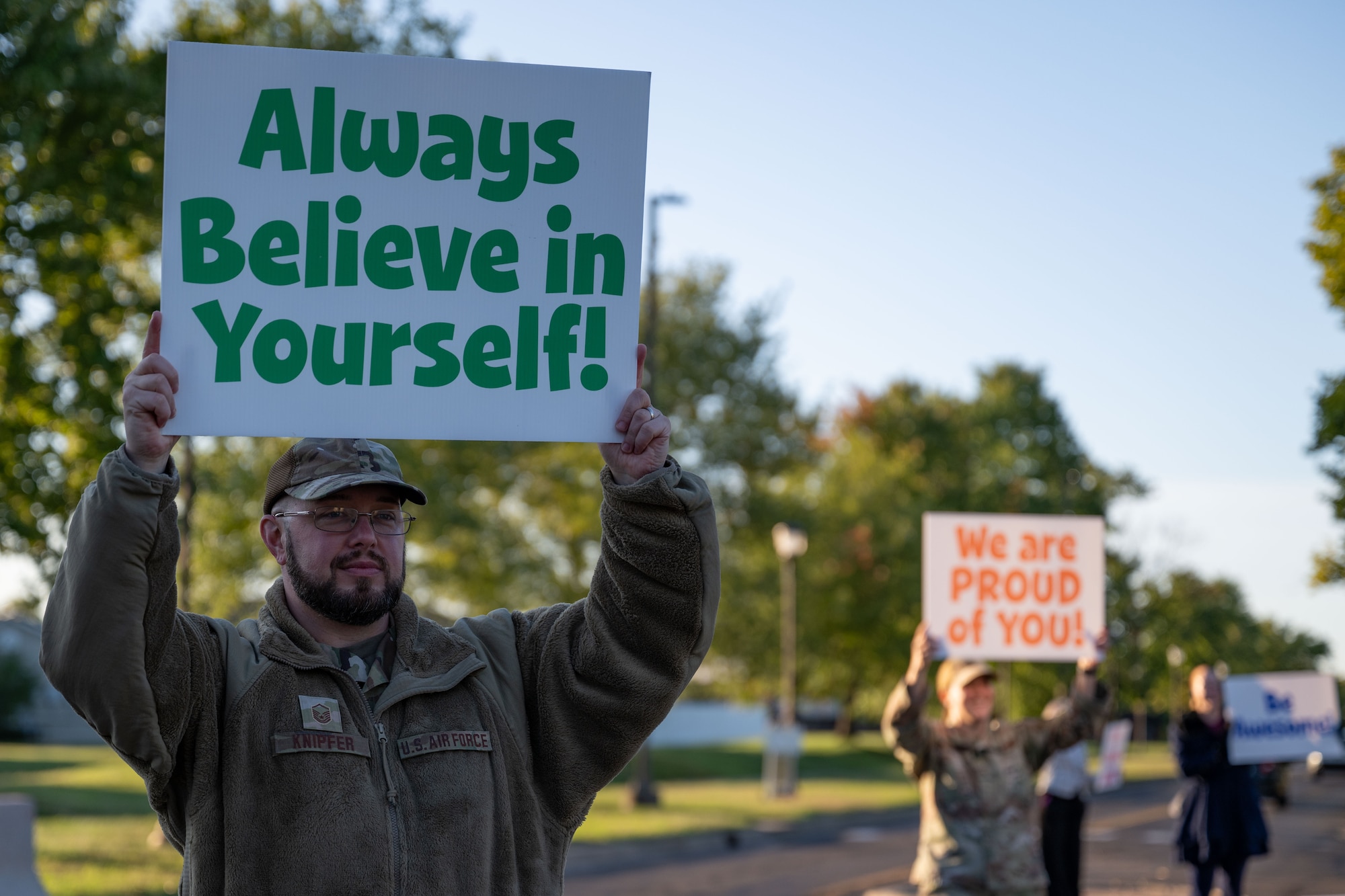 A U.S. Air Force Airmen holds up an encouraging sign during a National Suicide Prevention Awareness Month event at Joint Base McGuire-Dix-Lakehurst, N.J., Sept. 3, 2024. The month of September is the National Suicide Prevention Awareness Month where many organizations make a concerted effort to destigmatize the mental health struggles that many may face and take the opportunity to educate the public on recognizing signs someone is need of support as well as the avenues to receive support. (U.S. Air Force photo by Staff Sgt. Monica Roybal)