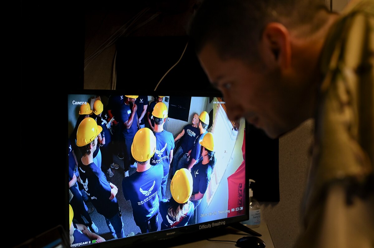 U.S. Staff Sgt. Jon Hanson, 312th Training Squadron instructor, demonstrates how the HAL mannequin assists fire protection specialists with their training during Career Day, Goodfellow Air Force Base, Texas, Aug. 28, 2024. Prospects were shown several demonstrations throughout the day that showcased training and operational applications. (U.S. Air Force photo by Airman 1st Class Madi Collier)