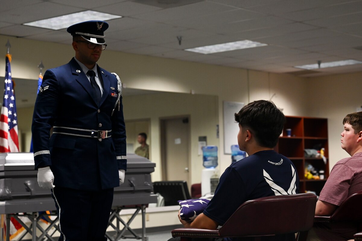 U.S. Air Force Airman 1st Class Anthony Cragin, 17th Force Support Squadron ceremonial guardsman, stands at attention during a demonstration for Career Day, Goodfellow Air Force Base, Aug. 28, 2024. Prospects learned about additional career opportunities that are afforded to them beyond performing the duties of their primary job. (U.S. Air Force photo by Airman 1st Class Madi Collier)