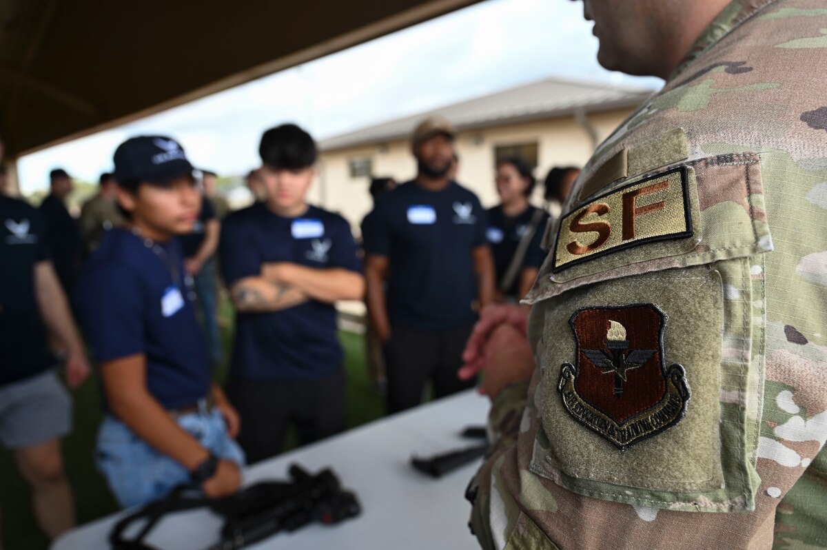 U.S. Air Force Staff Sgt. Kevin Campbell,17th Security Forces Squadron combat arms instructor, talks to prospects about the different equipment used by security forces personnel during Career Day, Goodfellow Air Force Base, Aug. 28, 2024. While visiting the 17th SFS, prospects received a K-9 demonstration, spoke to combat arms instructors and were able to ask questions about what technical training looks like. Individuals interested in security forces had one-on-one conversations with Airmen about their time in the Air Force. (U.S. Air Force photo by Airman 1st Class Madi Collier)