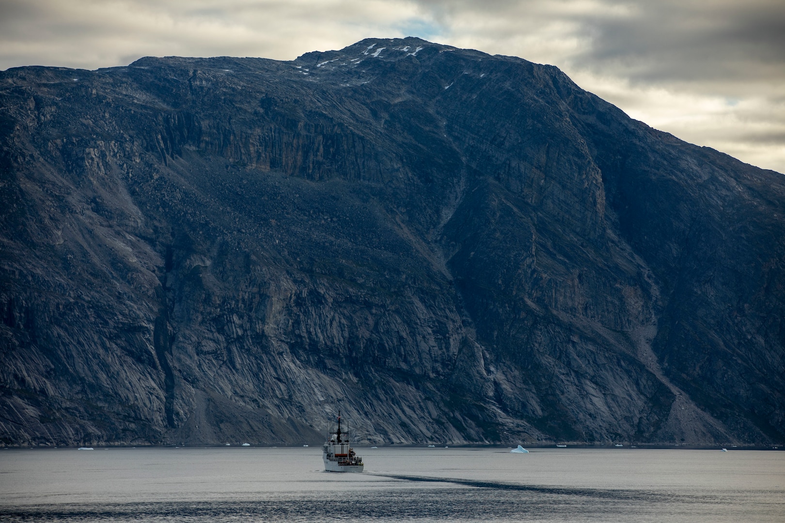 The U.S. Coast Guard Cutter Northland (WMEC 904) transits Godthab's Fjord alongside the Arleigh Burke-class guided-missile destroyer USS Delbert D. Black (DDG 119) during Operation NANOOK (OP NANOOK), Aug. 21, 2024. OP NANOOK is the Canadian Armed Forces' annual series of Arctic exercises designed to enhance defense capabilities, ensure the security of northern regions, and improve interoperability with Allied forces. Black participated in the operation alongside the U.S. Coast Guard and Canadian and Danish Allies to bolster Arctic readiness and fulfill each nation's defense commitments. (U.S. Navy Photo by Mass Communication Specialist 3rd Class Rylin Paul)