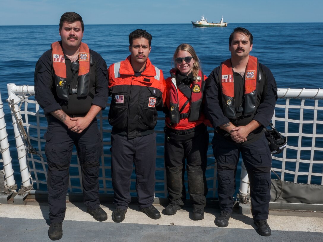 U.S. Coast Guard Cutter Northland (WMEC 904) crew members pose for a group photo with an embarked fisheries officer from the Canadian Department of Fisheries and Oceans, Aug. 3, 2024, prior to a boarding inspection while at sea in the Atlantic Ocean; from left to right: Coast Guard Petty Officer 1st Class Brandon Cusick, Coast Guard Petty Officer 3rd Class Elijah Mateus, Canadian Department of Fisheries and Oceans fisheries officer Elizabeth Brennan and Coast Guard Petty Officer 3rd Class Desmond Moore. Northland embarked Brennan, who is a Northwest Atlantic Fisheries Organization (NAFO) trained inspector, to aid in international fisheries enforcement in the northwest Atlantic Ocean as part of Operation Nanook. (U.S. Coast Guard photo by Petty Officer 3rd Class Anthony Randisi)