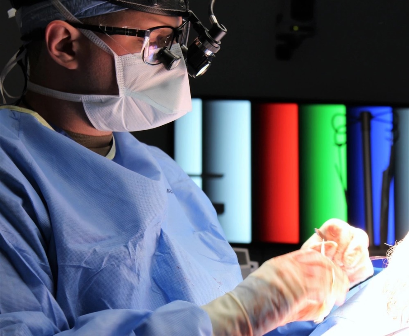 Maj. Andrew Jenzer, Program Director, Oral and Maxillofacial Surgery Residency, Womack Army Medical Center performing facial reconstruction from trauma.