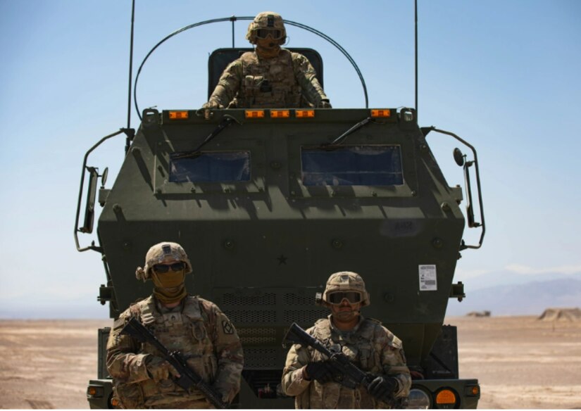 U.S. Army Soldier assigned to Alpha Battery, 1st Battalion, 14 Field Artillery Regiment stands in front a M142 High Mobility Artillery Rocket System. during Southern Fenix 24 near Campo Militar Pozo Almonte, Chile on Aug. 29, 2024.