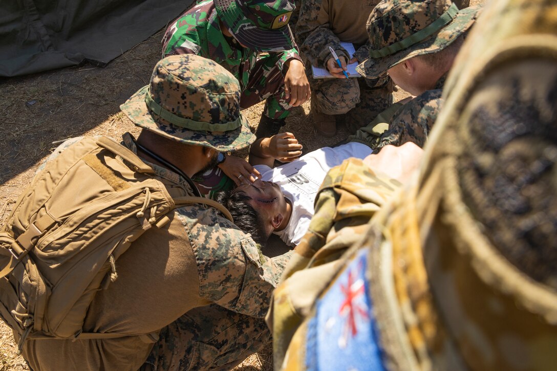 U.S. Sailors with Combat Logistics Battalion 5 (Reinforced), Marine Rotational Force – Darwin 24.3, Australian Defence Force Soldiers, and Indonesian National Armed Forces, prepare a simulated casualty for treatment as part of a mass casualty exercise during Exercise Bhakti Kanyini AUSINDO 24 at Robertson Barracks, NT, Australia, Aug. 20, 2024.