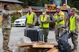 Service members with the Alaska Air, Army National Guard, and Naval Militia clear debris off the road while assisting local authorities and tribal emergency operations personnel in the Mendenhall Valley, Juneau, Alaska, Aug. 14, 2024. The State Emergency Operations Center activated 60 Alaska Organized Militia members from the Alaska National Guard, Alaska Naval Militia, and Alaska State Defense Force as part of Joint Task Force – Juneau to assist with disaster debris removal following recent glacial outburst flooding. (Alaska National Guard photo by Sgt. Marc Marmeto)