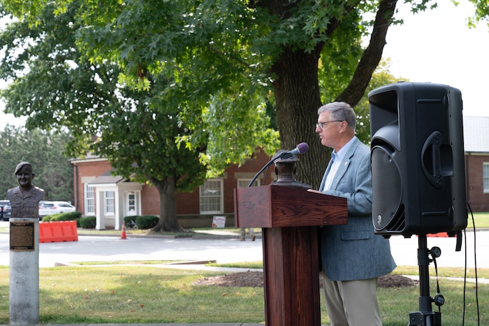 Retired U.S. Air Force Col. John Strube speaks at a podium.