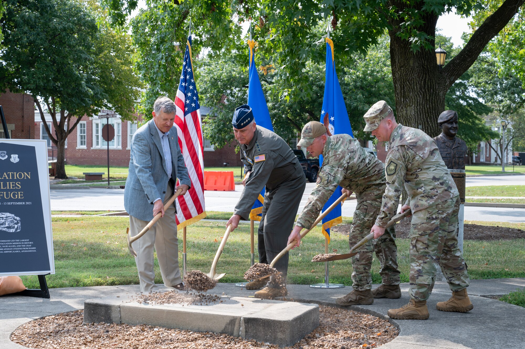 Retired Colonel John Strube, Gen. Mike Minihan, SSgt. Morgan Reed, and Col. John Poole break ground