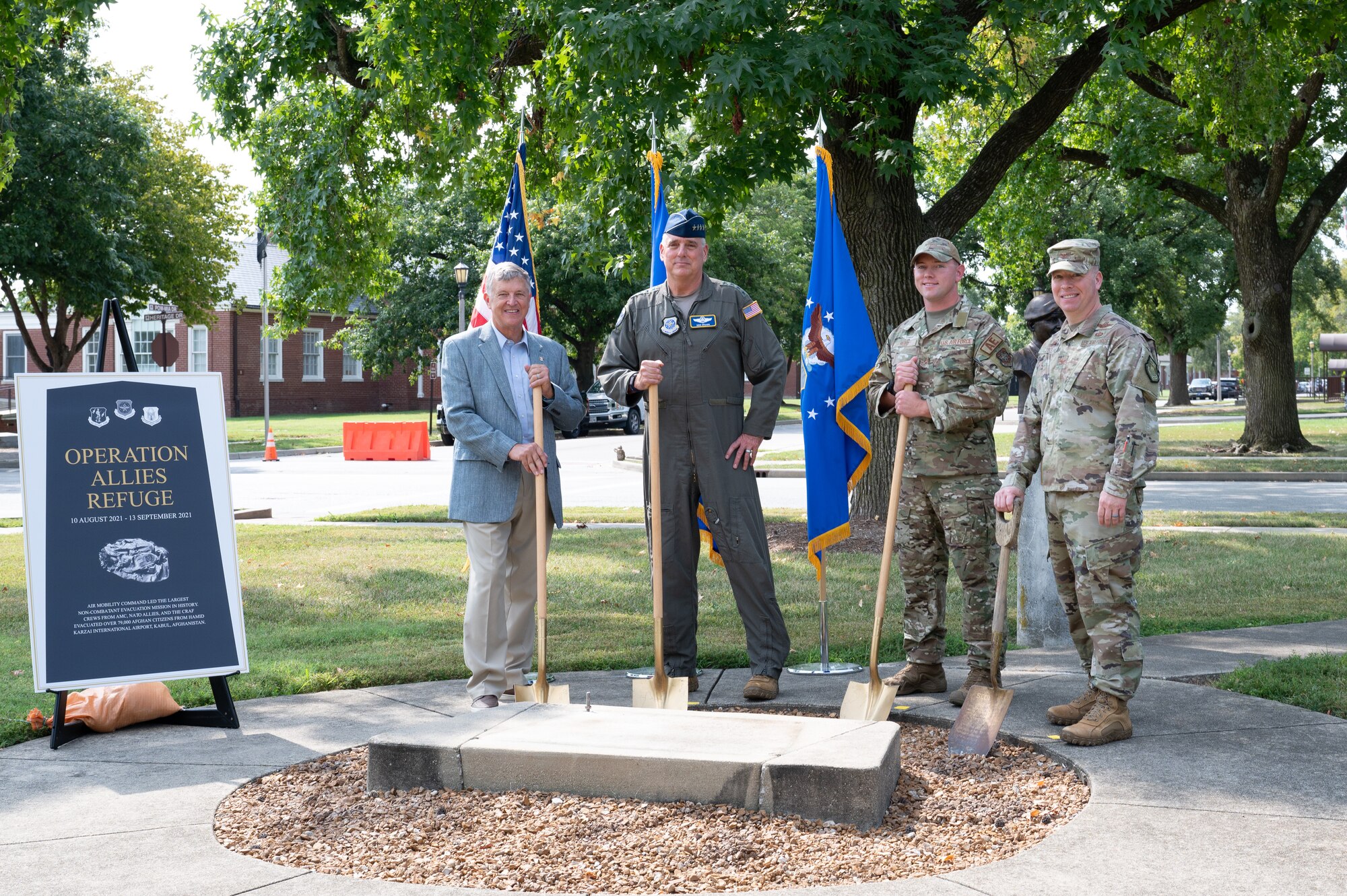 Retired U.S. Air Force Col. John Strube, Gen. Mike Minihan, Staff Sgt. Morgan Reed, and Col. John Poole stand with shovels, ready to break ground