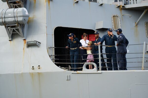 A woman and her daughter embrace on the deck of the USS William P. Lawrence (DDG 110)