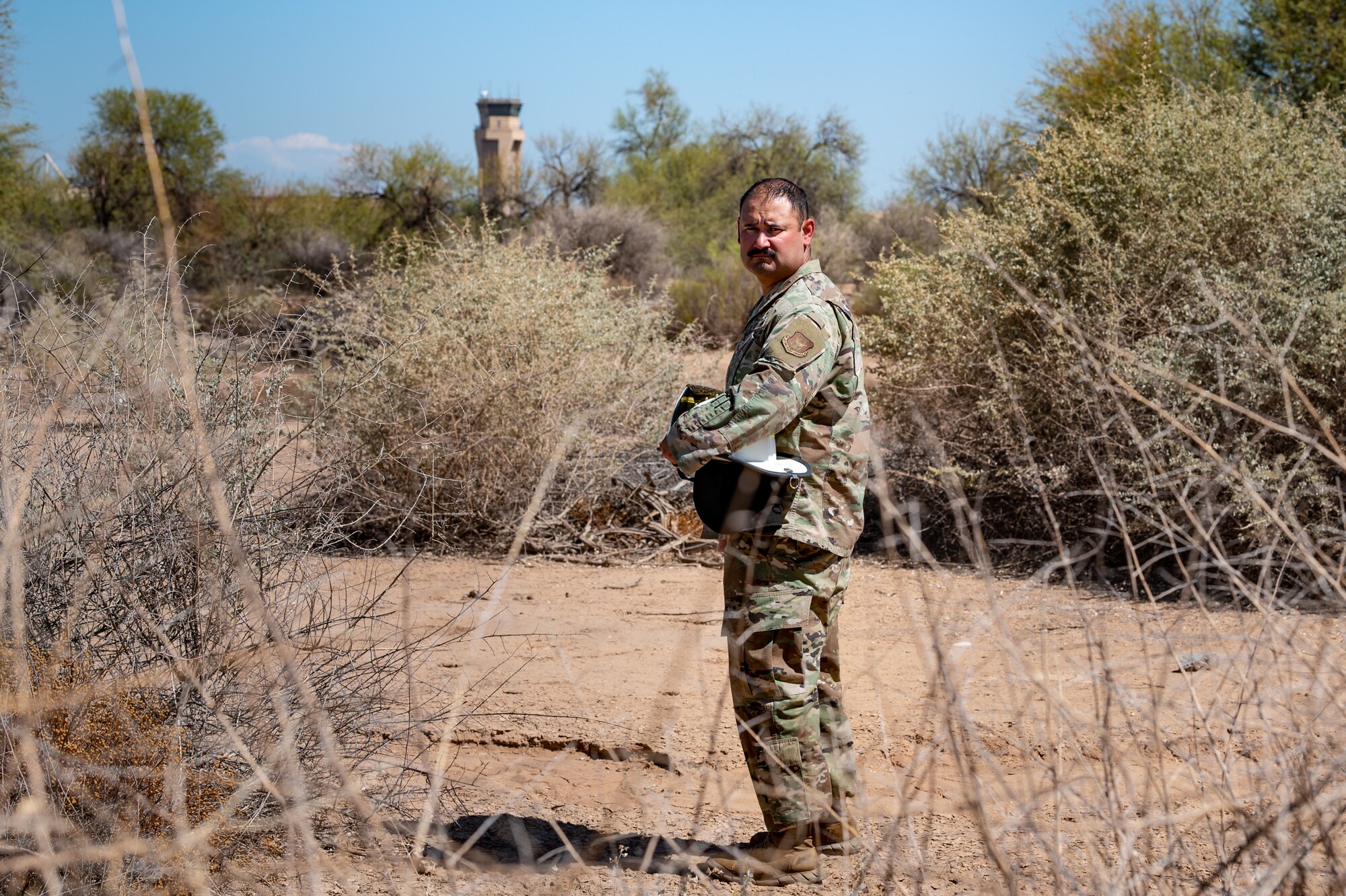 Reserve Citizen Airman Tech. Sgt. Orlando Rodriguez, senior enlisted leader for the 944th Operations Group Detachment 1 at Holloman Air Force Base, New Mexico, walks through the desert landscape near Luke Air Force Base, Arizona, on Sept. 4, 2024. Rodriguez serves as a volunteer firefighter and is dedicated to protecting his community in High Rolls, New Mexico. (U.S. Air Force photo by Tech. Sgt. Tyler J. Bolken)
