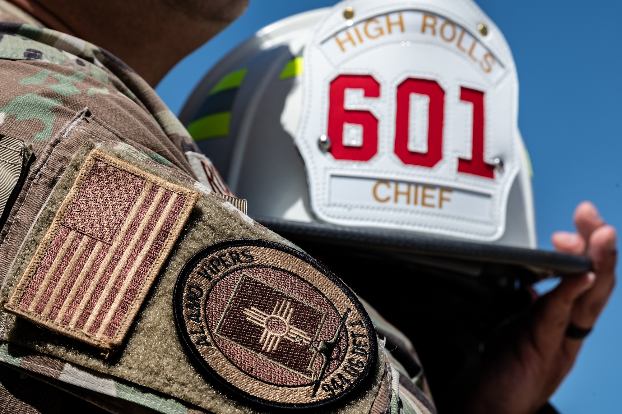 A close-up view of Reserve Citizen Airman Tech. Sgt. Orlando Rodriguez's firefighter helmet and uniform at Luke Air Force Base, Ariz., on Sept. 4, 2024. Rodriguez, senior enlisted leader for the 944th Operations Group Detachment 1 at Holloman Air Force Base, New Mexico, serves as the fire chief for the High Rolls Volunteer Fire Department in New Mexico. (U.S. Air Force photo by Tech. Sgt. Tyler J. Bolken)