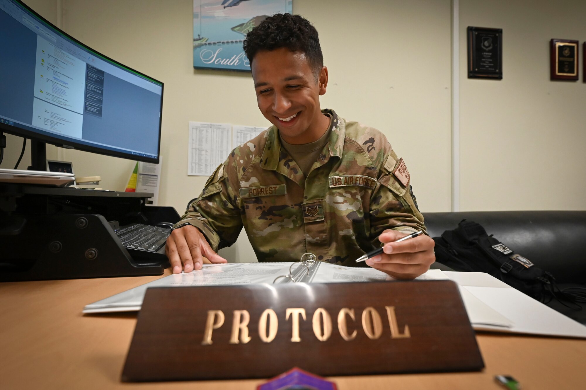 Staff Sgt. Bryson Forrest, 8th Fighter Wing noncommissioned officer in charge of protocol, reviews an itinerary .