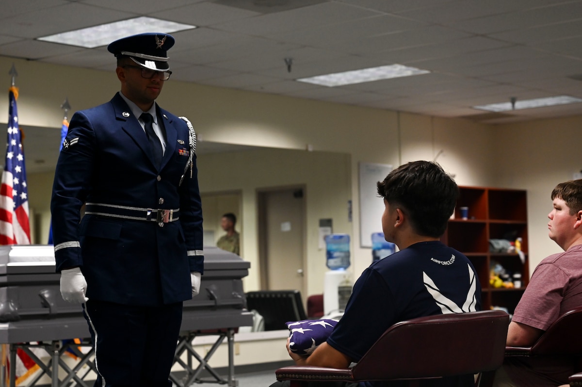 U.S. Air Force Airman 1st Class Anthony Cragin, 17th Force Support Squadron ceremonial guardsman, stands at attention during a demonstration for Career Day, Goodfellow Air Force Base, Aug. 28, 2024. Prospects learned about additional career opportunities that are afforded to them beyond performing the duties of their primary job. (U.S. Air Force photo by Airman 1st Class Madi Collier)