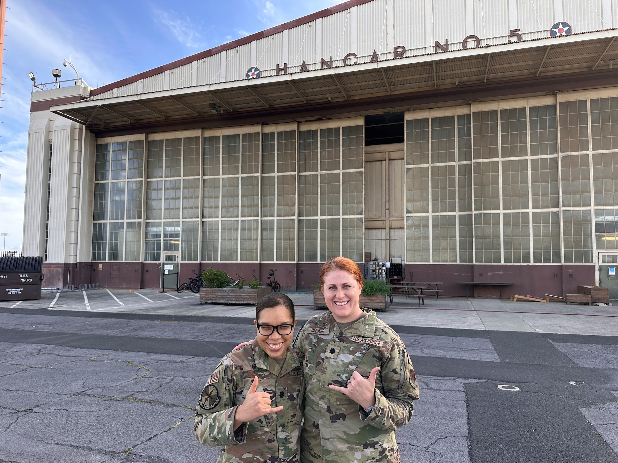 Leadership pose in front of hanger