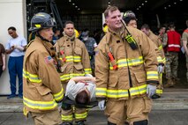 U.S. Air Force firefighters assigned to the 35th Civil Engineering Squadron carry a casualty actor on a stretcher during an Emergency Management exercise.