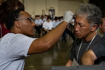 U.S. Air Force Senior Airman Niles Tilley, 35th Operational Medical Readiness Squadron public health technician, applies moulage makeup to a casualty actor during an Emergency Management exercise.