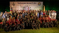 U.S. Air Force, Royal Australian Air Force, Bangladesh Air Force, Hellenic Air Force, Republic of Singapore Air Force, Indian Air Force, and United Arab Emirates Air Force members pose for a photo with cultural performers from India concluding the Tarang Shakti 24 phase II opening ceremony at Jodhpur Air Force Station, Rajasthan, India, Aug. 30, 2024. Throughout TS24 Phase II, the Indian Air Force hosted 28 countries for the multinational exercise to build partnerships.