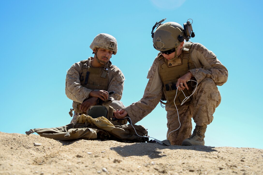 U.S. Marine Corps Sgt. Adrian Negron Dejesus, left, a York, Pennsylvania native and psychological operations influence specialist with III Marine Expeditionary Force, and Sgt. Krystal Gallego, a Houston, Texas native and PSYOP influence specialist with Second Air-Naval Gunfire Liaison Company, II Marine Expeditionary Force Information Group, sets up a next generation loudspeaker during Service Level Training Exercise 5-24 at Marine Corps Air-Ground Combat Center, Twentynine Palms, California, Aug. 22, 2024. The purpose of SLTE 5-24 is to create a challenging, realistic training environment that produces combat-ready forces capable of operating as an integrated Marine Air Ground Task Force. (U.S. Marine Corps photo by Lance Cpl. Grace Stover)
