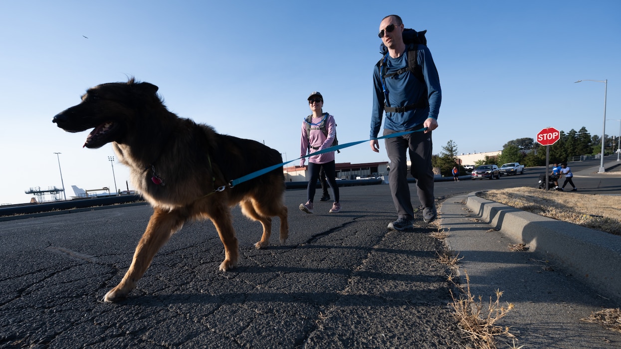 Airmen and their dog participate in memorial run