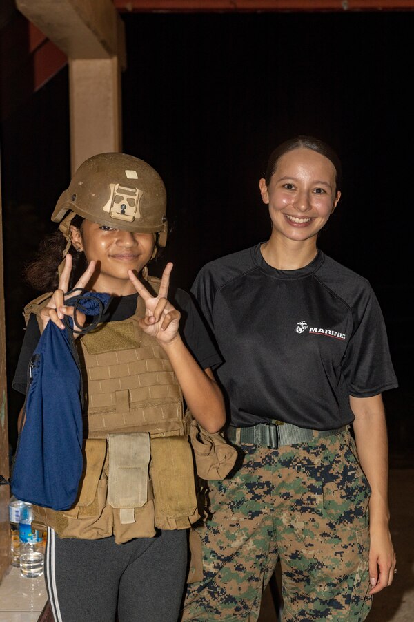 U.S. Marine Corps Lance Cpl. Victoria Luna, an administrative specialist with Combat Logistics Battalion 13, Combat Logistics Regiment 17, 1st Marine Logistics Group, poses with the local community for a photo during a local night market as part of exercise Koa Moana 24, at Koror, Palau, Aug. 24, 2024. Marines from Koa Moana 24 assisted recruiters from Recruiting Station San Diego, 12th Marine Corps District Headquarters, in expanding their presence in Palau During Koa Moana’s deployment throughout the Indo-Pacific region, U.S. Marines and Sailors from I Marine Expeditionary Force work to strengthen alliances and partnerships with development of interoperable capabilities, combined operations, theater security cooperation, and capacity-building efforts. (U.S. Marine Corps photo by Cpl. Daniel Childs)