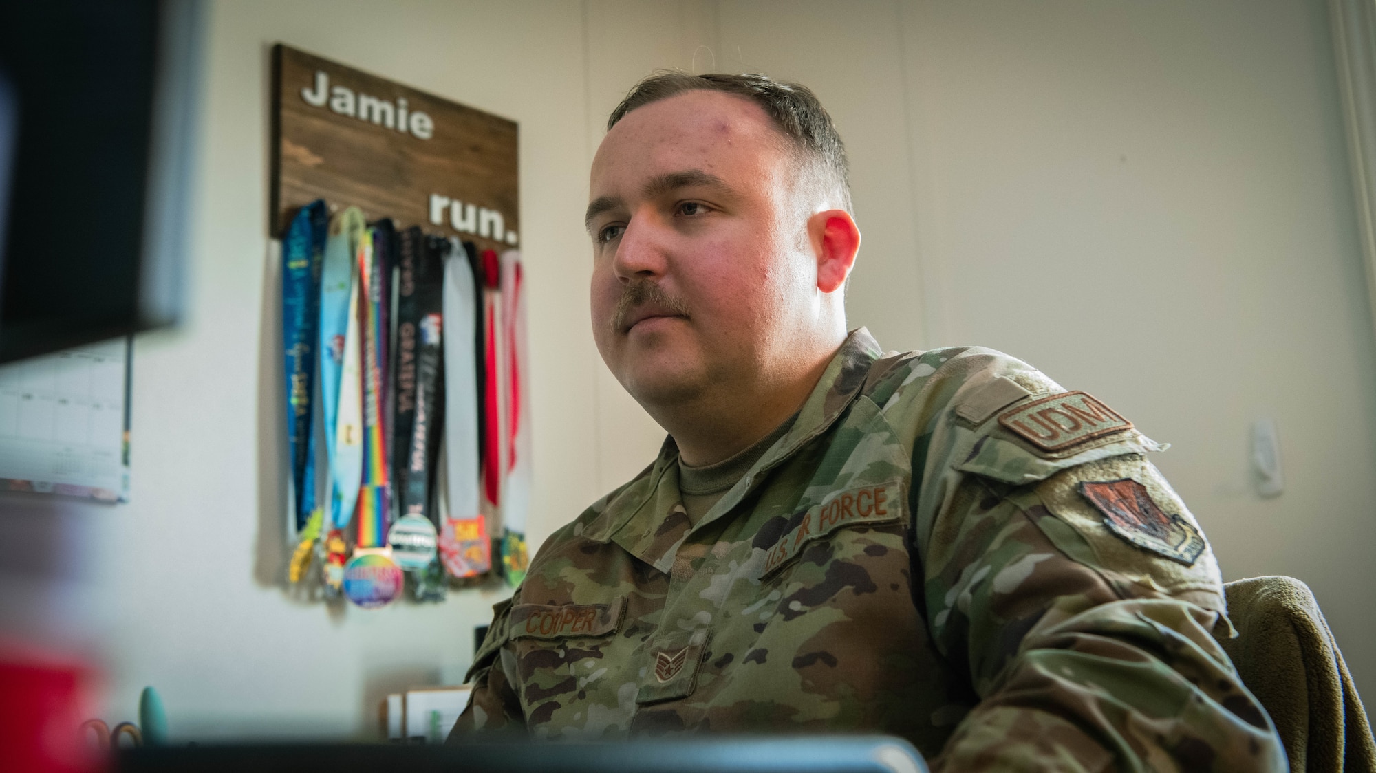 An Airman performs work on his computer.