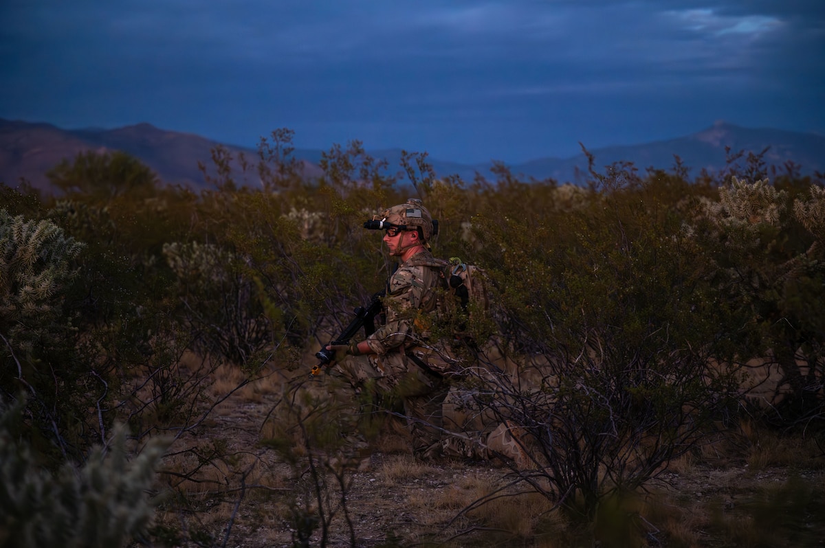 A U.S. Air Force pararescueman assigned to the 68th Rescue Squadron looks for opposing forces during the Combat Leader Course at Davis-Monthan Air Force Base, Arizona, Aug. 26, 2024. The CLC was designed to enhance the leadership skills of pararescuemen. (U.S. Air Force photo by Airman 1st Class Jasmyne Bridgers-Matos)