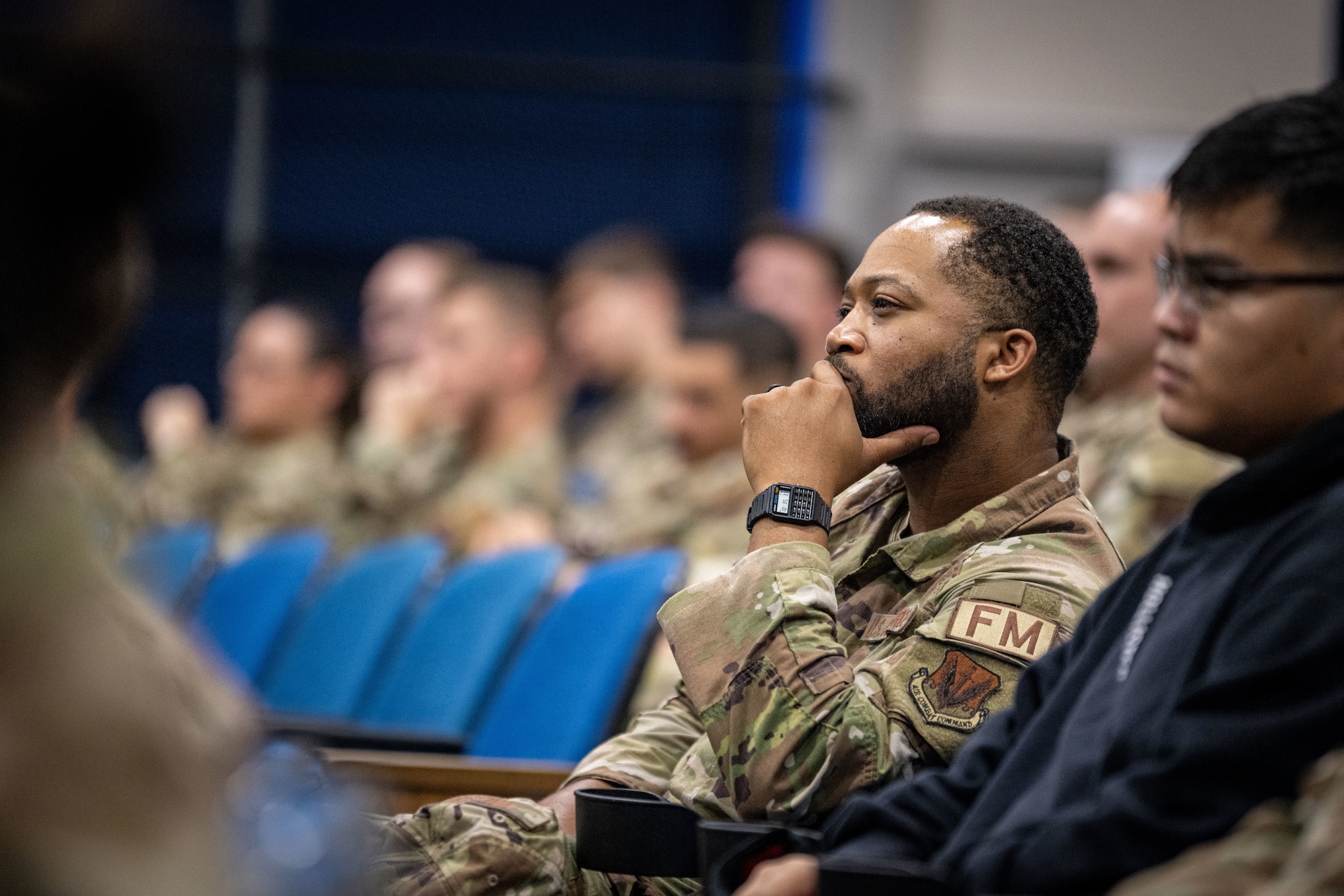 A U.S. Air Force Airman from the 23rd Comptroller Squadron listens to Tra Battle’s mental health speech at Moody Air Force Base, Georgia, Aug. 29, 2024. Battle's message encouraged service members to take care of their mental health and seek help when they need it. (U.S. Air Force photo by 2nd Lt. Benjamin Williams).