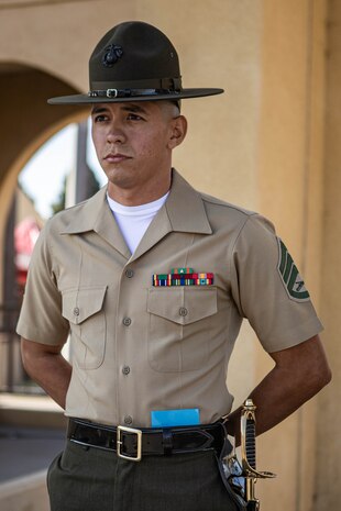 U.S. Marine Corps Staff Sgt. Aaron Ruiz, a senior drill instructor with Lima Company, 3rd Recruit Training Battalion, waits to begin his final drill evaluation at Marine Corps Recruit Depot San Diego, California, Aug. 24, 2024. During the final drill evaluation, the platoons are scored based on their uniforms, bearing, and movements, as well as the senior drill instructor’s cadence, sword control, and movement commands. (U.S. Marine Corps photo by Sgt. Jesse K. Carter-Powell)