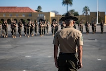 U.S. Marine Corps Staff Sgt. Aaron Ruiz, a senior drill instructor with Lima Company, 3rd Recruit Training Battalion, calls his platoon to fall in during a final drill evaluation at Marine Corps Recruit Depot San Diego, California, Aug. 24, 2024. During the final drill evaluation, the platoons are  scored based on their uniforms, bearing, and movements, as well as the senior drill instructor’s cadence, sword control, and movement commands. (U.S. Marine Corps photo by Sgt. Jesse K. Carter-Powell)