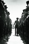 U.S. Marine Corps Staff Sgt. Jacob Landis, the drill master for 3rd Recruit Training Battalion, Recruit Training Regiment, inspects a platoon with Lima Company, 3rd Recruit Training Battalion during their final drill evaluation at Marine Corps Recruit Depot San Diego, California, Aug. 24, 2024. During the final drill evaluation, the platoons are scored based on their uniforms, bearing, and movements, as well as the senior drill instructor’s cadence, sword control, and movement commands. (U.S. Marine Corps photo illustration by Sgt. Jesse K. Carter-Powell)