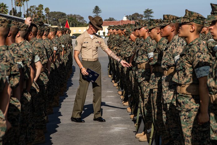 U.S. Marine Corps Staff Sgt. Jacob Landis, the drill master for 3rd Recruit Training Battalion, Recruit Training Regiment, inspects a platoon with Lima Company, 3rd Recruit Training Battalion during their final drill evaluation at Marine Corps Recruit Depot San Diego, California, Aug. 24, 2024. During the final drill evaluation, the platoons are scored based on their uniforms, bearing, and movements, as well as the senior drill instructor’s cadence, sword control, and movement commands. (U.S. Marine Corps photo by Sgt. Jesse K. Carter-Powell)