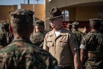 U.S. Marine Corps Staff Sgt. Logan Stogdill, a drill master with 2nd Recruit Training Battalion, Recruit Training Regiment, inspects a platoon with Lima Company, 3rd Recruit Training Battalion during their final drill evaluation at Marine Corps Recruit Depot San Diego, California, Aug. 24, 2024. During the final drill evaluation, the platoons are scored based on their uniforms, bearing, and movements, as well as the senior drill instructor’s cadence, sword control, and movement commands. (U.S. Marine Corps photo by Sgt. Jesse K. Carter-Powell)