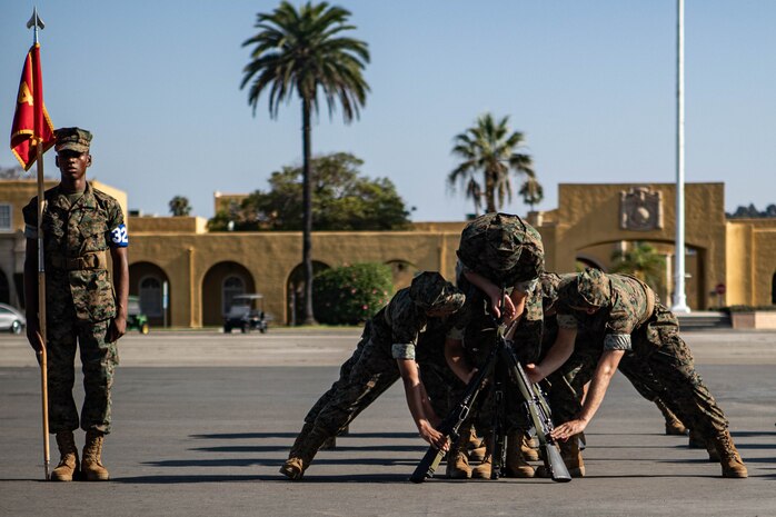 U.S. Marine Corps recruits with Lima Company, 3rd Recruit Training Battalion, create rifle stacks as part of their final drill evaluation at Marine Corps Recruit Depot San Diego, California, Aug. 24, 2024. During the final drill evaluation, the platoons are scored based on their uniforms, bearing, and movements, as well as the senior drill instructor’s cadence, sword control, and movement commands. (U.S. Marine Corps photo by Sgt. Jesse K. Carter-Powell)