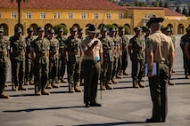 U.S. Marine Corps Staff Sgt. Anthony Mejias, a senior drill instructor with Lima Company, 3rd Recruit Training Battalion, left, reports that his platoon is ready for evaluation to Gunnery Sgt. Donald Vilchek, the drill master of Recruit Training Regiment, Marine Corps Recruit Depot San Diego, right, as part of a final drill evaluation at MCRD San Diego, California, Aug. 24, 2024. During the final drill evaluation, the platoons are scored based on their uniforms, bearing, and movements, as well as the senior drill instructor’s cadence, sword control, and movement commands. (U.S. Marine Corps photo by Sgt. Jesse K. Carter-Powell)