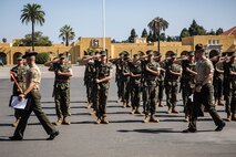 U.S. Marine Corps Gunnery Sgt. Donald Vilchek, the drill master of Recruit Training Regiment, Marine Corps Recruit Depot San Diego, left, and Gunnery Sgt. Kyle Wilton, a chief drill instructor with Echo Company, 2nd Recruit Training Battalion, right, inspect a platoon with Lima Company, 3rd Recruit Training Battalion during a final drill evaluation at Marine Corps Recruit Depot San Diego, California, Aug. 24, 2024. During the final drill evaluation, the platoons are scored based on their uniforms, bearing, and movements, as well as the senior drill instructor’s cadence, sword control, and movement commands. (U.S. Marine Corps photo by Sgt. Jesse K. Carter-Powell)