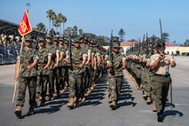 U.S. Marine Corps Staff Sgt. Anthony Mejias, a senior drill instructor with Lima Company, 3rd Recruit Training Battalion, marches his platoon as part of a final drill evaluation at Marine Corps Recruit Depot San Diego, California, Aug. 24, 2024. During the final drill evaluation, the platoons are scored based on their uniforms, bearing, and movements, as well as the senior drill instructor’s cadence, sword control, and movement commands. (U.S. Marine Corps photo by Sgt. Jesse K. Carter-Powell)