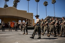 U.S. Marine Corps Staff Sgt. Anthony Mejias, a senior drill instructor with Lima Company, 3rd Recruit Training Battalion, marches his platoon as part of a final drill evaluation at Marine Corps Recruit Depot San Diego, California, Aug. 24, 2024. During the final drill evaluation, the platoons are scored based on their uniforms, bearing, and movements, as well as the senior drill instructor’s cadence, sword control, and movement commands. (U.S. Marine Corps photo by Sgt. Jesse K. Carter-Powell)