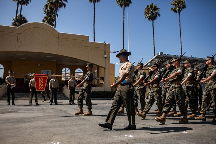 U.S. Marine Corps Staff Sgt. Anthony Mejias, a senior drill instructor with Lima Company, 3rd Recruit Training Battalion, marches his platoon as part of a final drill evaluation at Marine Corps Recruit Depot San Diego, California, Aug. 24, 2024. During the final drill evaluation, the platoons are scored based on their uniforms, bearing, and movements, as well as the senior drill instructor’s cadence, sword control, and movement commands. (U.S. Marine Corps photo by Sgt. Jesse K. Carter-Powell)