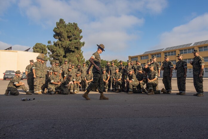 U.S. Marine Corps Staff Sgt. Alexis Molina, a drill instructor with Delta Company, 1st Recruit Training Battalion, teaches drill to recruits during a post exchange and haircut call at Marine Corps Recruit Depot San Diego, California, Aug. 19, 2024. Recruits are allowed to go to the PX to buy necessary supplies and receive haircuts weekly during their time at MCRD San Diego in order to maintain uniform appearance and promote good hygiene throughout recruit training. (U.S. Marine Corps photo by Lance Cpl. Janell B. Alvarez)