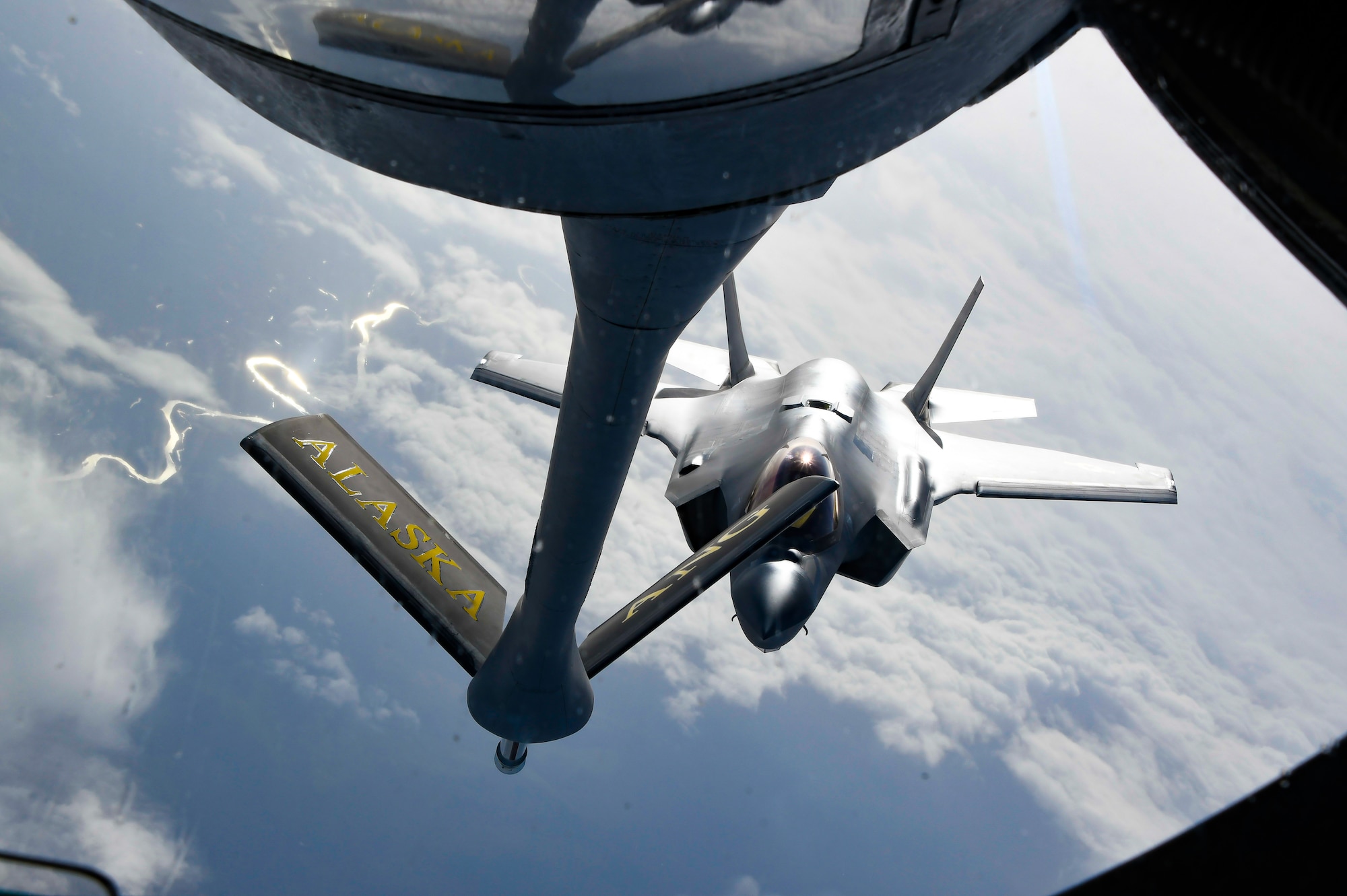 A U.S. Air Force KC-135 Stratotanker aircrew from the 168th Wing, Alaska Air National Guard, conducts aerial refueling operations for fighter aircraft participating in Red Flag Alaska