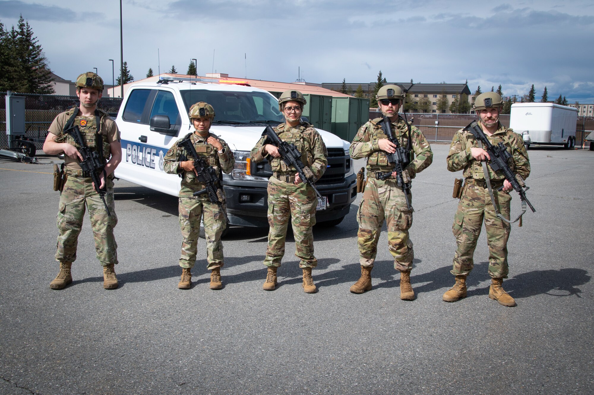 U.S. Air National Guard Staff Sgt. Joseph Villa, Tech Sgt. Aiyana Pangelinan, Staff Sgt. Jennifer Dasta-Cortes, Tech Sgt. Noah Belt and Master Sgt. Reuben Wright pose for a photo at Eielson Air Force Base while training for the Pacific Air Forces’ Combat Skills Assessment competition