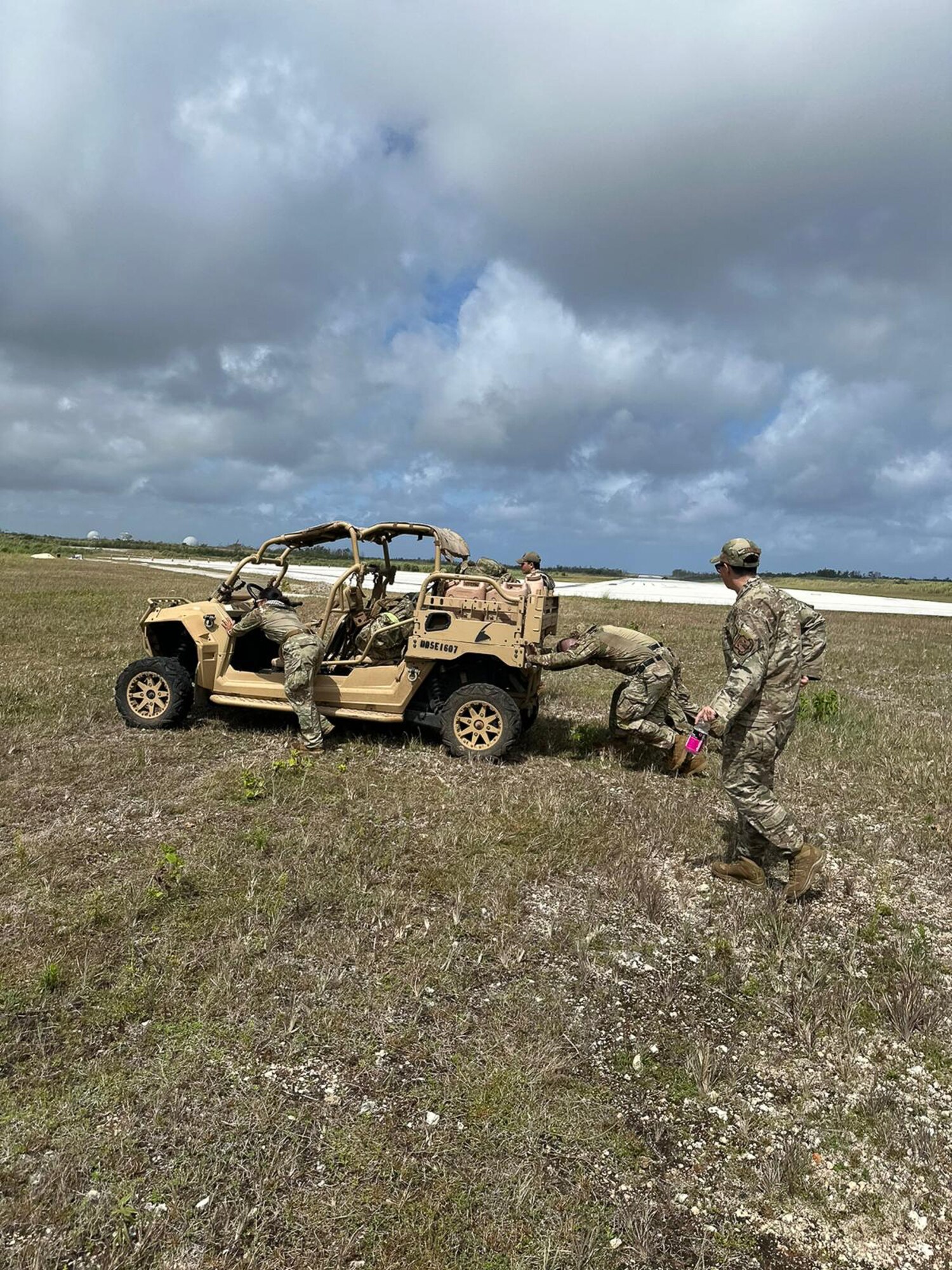 The 168th Security Forces members push a combat vehicle showcasing their strength while participating in the Pacific Air Forces’ Advanced Combat Skills Assessment