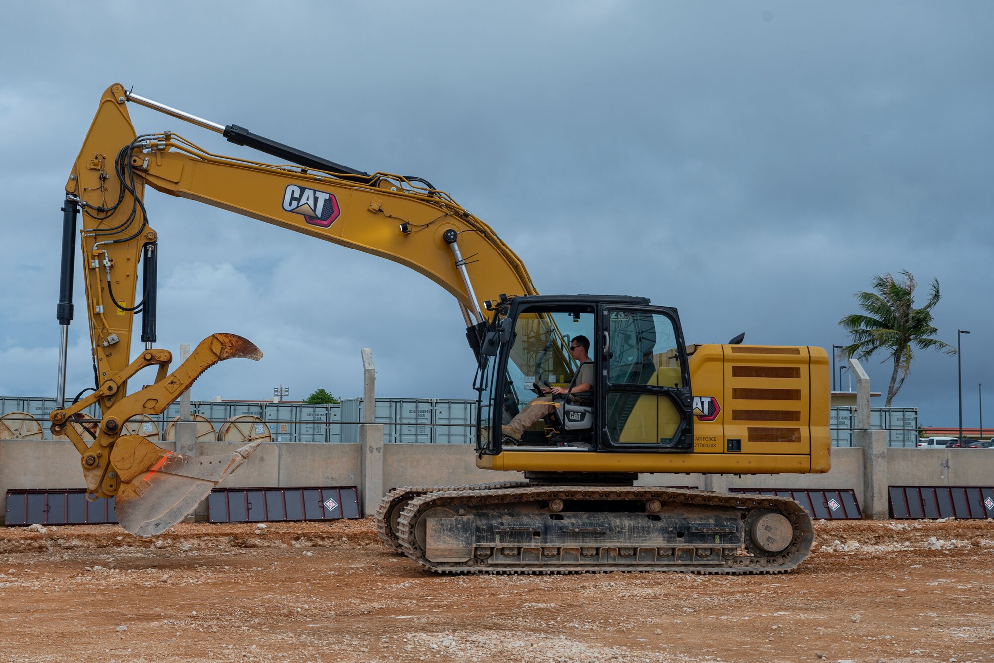 U.S. Air Force Airman 1st Class Alexander Williams, 554th Rapid Engineer Deployable Heavy Operational Repair Squadron Engineers pavements and construction equipment operator, operates an excavator in preparation to build a K-SPAN at Andersen Air Force Base, Guam, Aug. 29, 2024. A K-SPAN is a storage facility for deployable assets, which helps increase the lifetime of equipment. (U.S. Air Force photo by Senior Airman Jasmine M. Barnes)